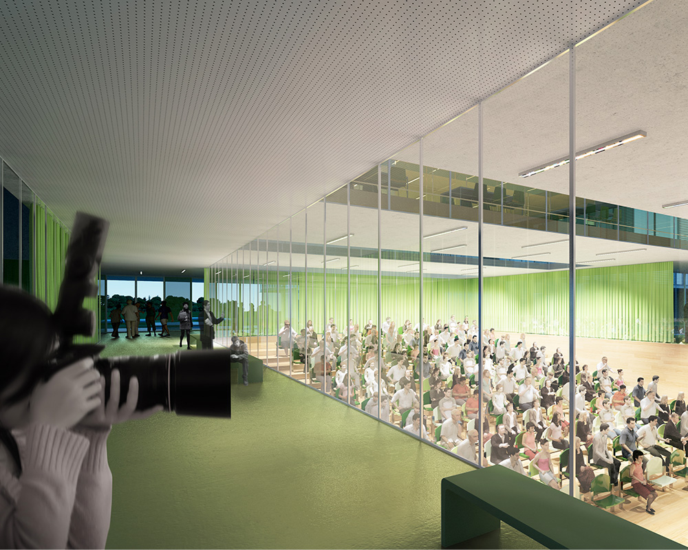 Una vetrata lascia intravedere un auditorium al livello sottostante