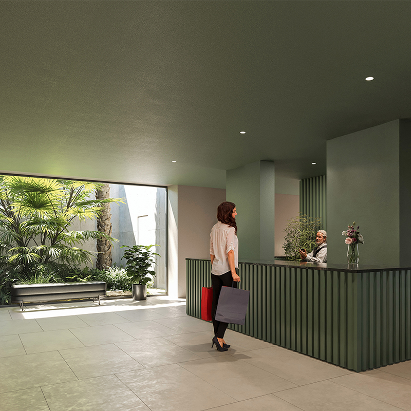 Lobby di ingresso delle residenze con patio sullo sfondo